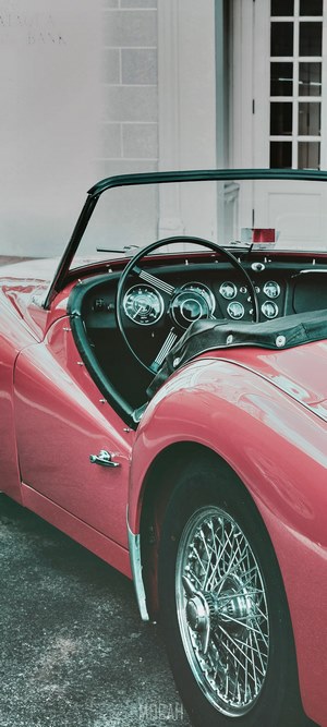 Red convertible car interior and wheel