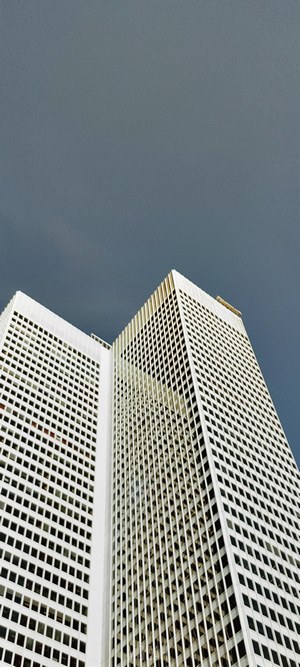 White high-rise buildings against a dark sky