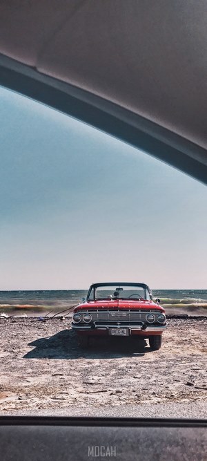 Red vintage Chevrolet car on a beach