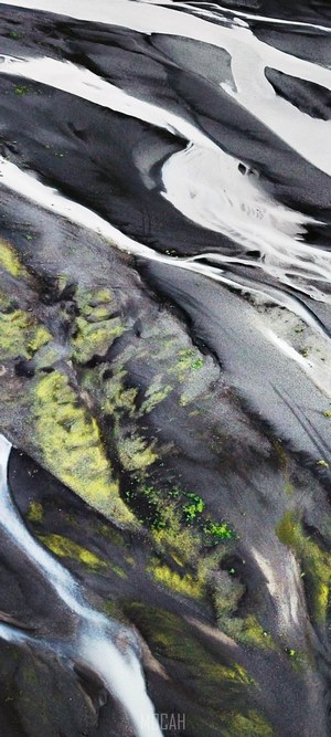 Aerial view of glacial rivers and mossy terrain