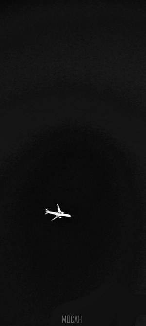 Airplane flying in dark sky