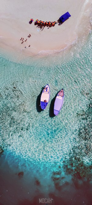 Aerial view of boats and people on a sandbank