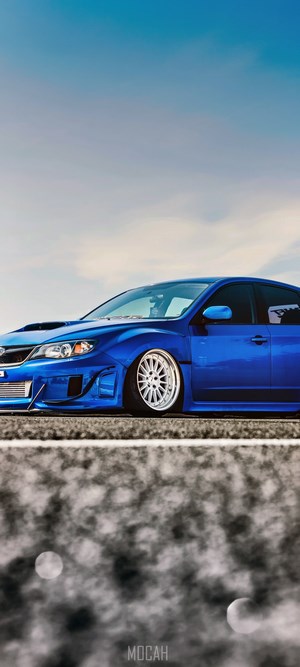 Blue Subaru WRX with custom rims