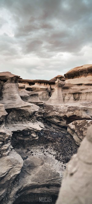 Eroded rock formations under a cloudy sky
