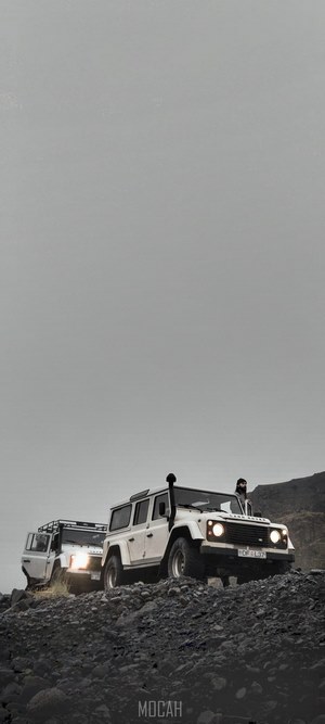 Two Land Rover Defenders on a rocky terrain in Iceland