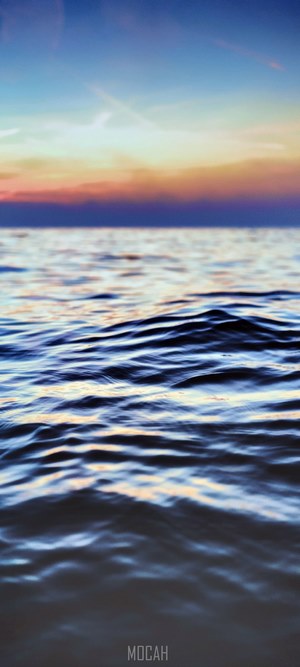 Ocean waves at sunset with colorful sky