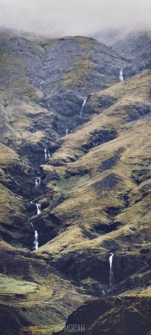 Waterfalls in the grassy mountains of Iceland
