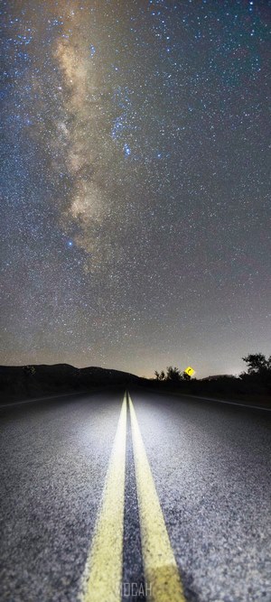 Road under the Milky Way at night
