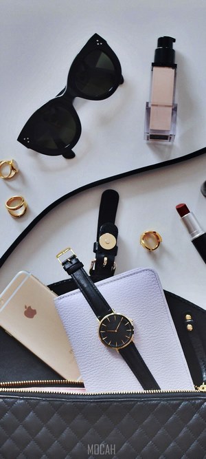 Contents of a woman's purse on a white surface