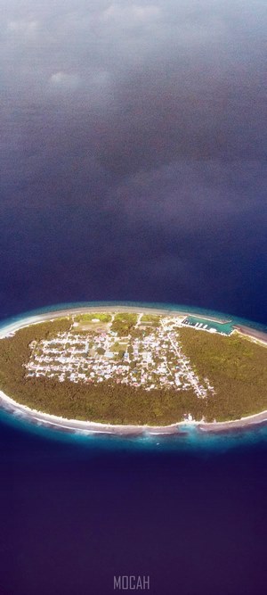 Aerial view of a tropical island village with a harbor