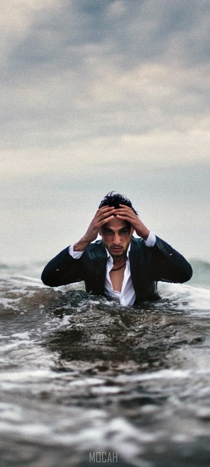 Man in suit in ocean waves