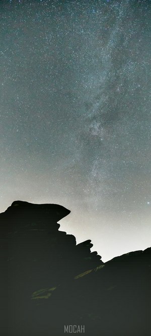 Starry sky over rocky silhouette