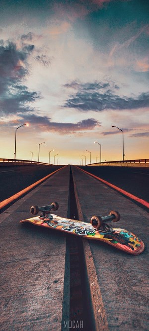 Skateboard on a bridge at sunset