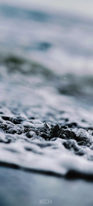 Close-up of wet pebbles and water