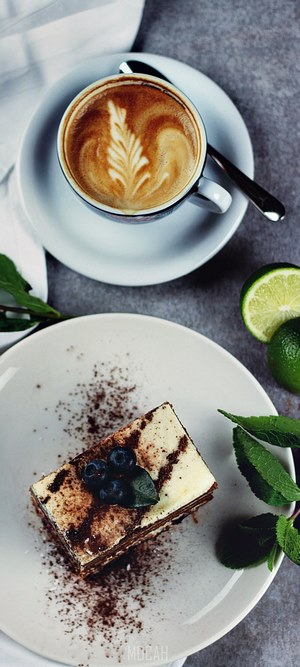 Coffee with latte art and cake with blueberries