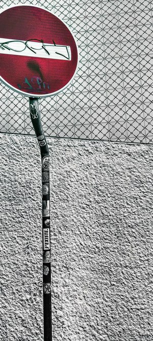 No entry sign with graffiti on pole