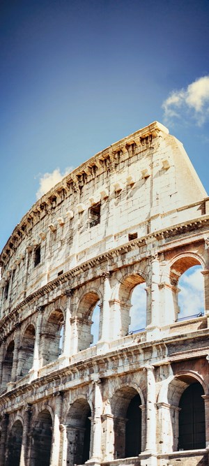 The Colosseum in Rome under a blue sky