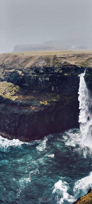 Waterfall cascading into the ocean in the Faroe Islands
