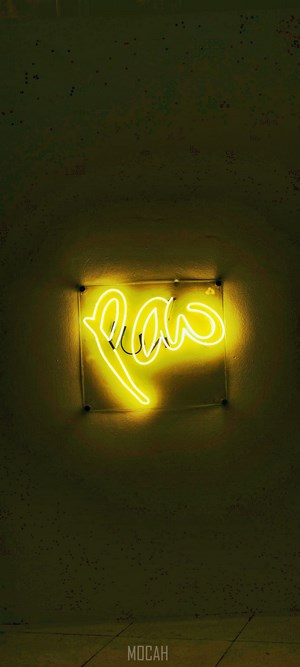 Yellow neon sign that says "Raw"