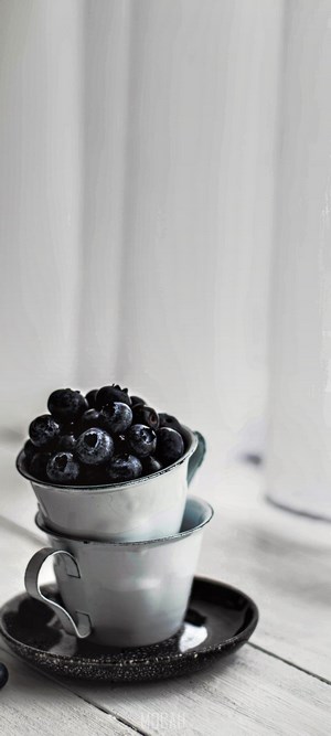 Blueberries in cups on a saucer