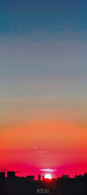 Sunset over city skyline with vibrant colors