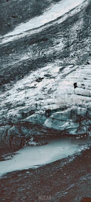 Glacier with meltwater pool and rocky terrain