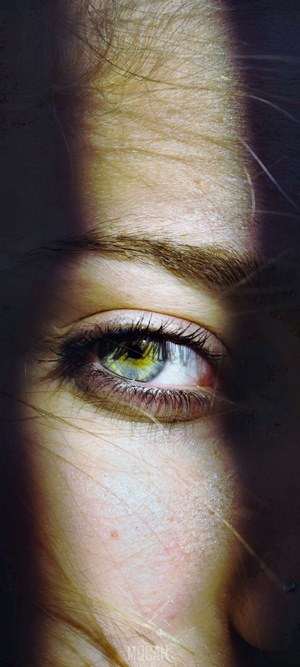 Close-up of a woman's eye with dramatic lighting