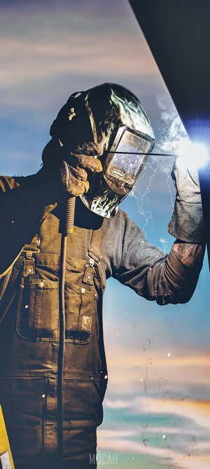 Welder working at sunset