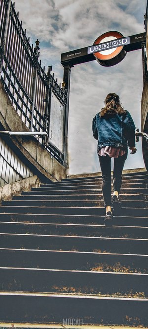 Woman climbing stairs at London Underground station