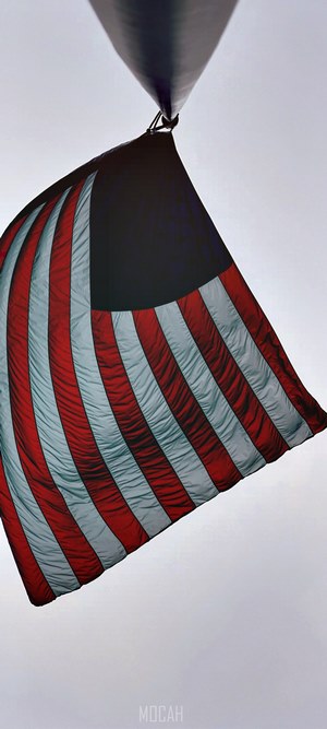 American flag on a pole against a cloudy sky