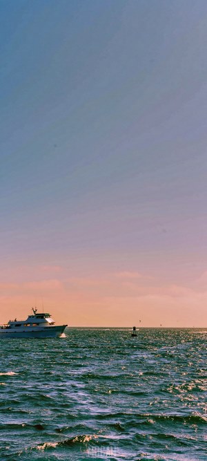 Yacht sailing on the ocean at sunset