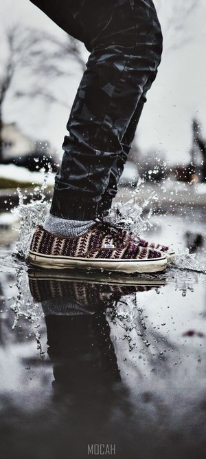Person splashing in puddle