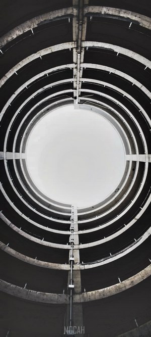 Circular spiral architecture viewed from below against sky