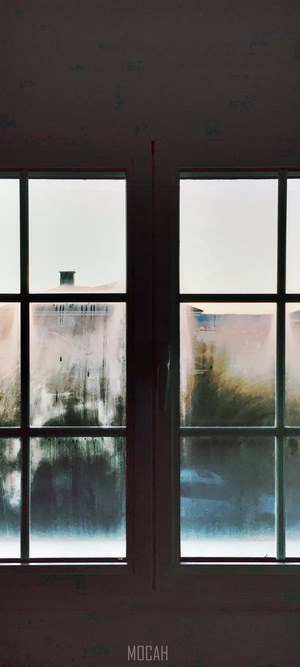Window with condensation and building view