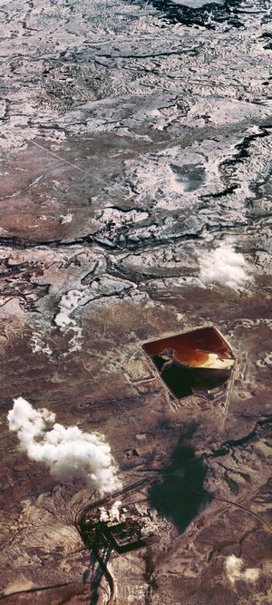 Aerial view of industrial site and mining pond