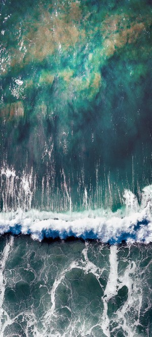 Aerial view of ocean waves crashing