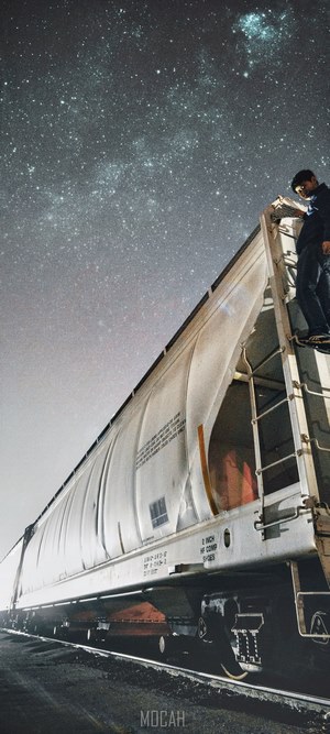 Man on train under starry night sky