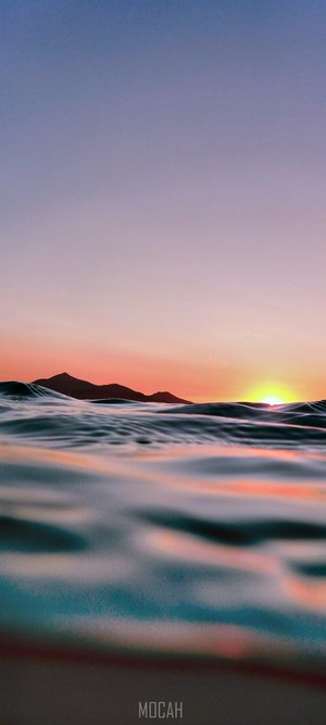 Sunset over the ocean with mountains