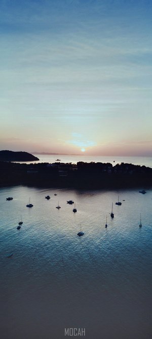 Boats in a harbor at sunset