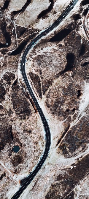 Aerial view of a winding road through a barren landscape