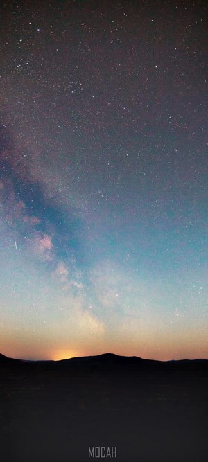 Milky Way over mountain silhouette at sunset