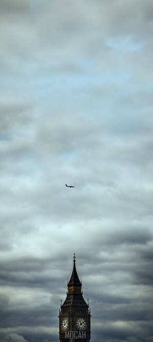 Airplane over Big Ben clock tower in London