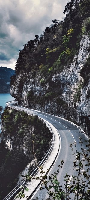 Curving Mountain Road Along Swiss Cliffs