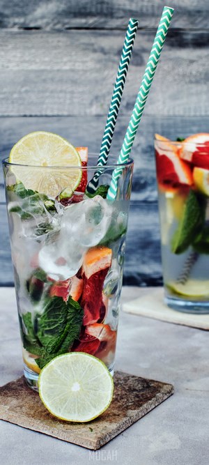Two detox water drinks with fruit and mint