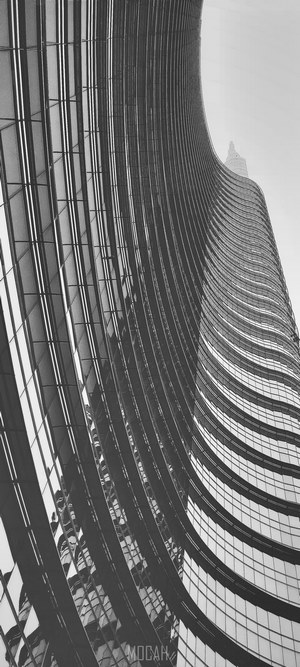 Curved skyscraper architecture against a clear sky