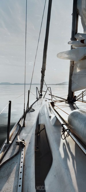 Sailboat on the water with land on the horizon
