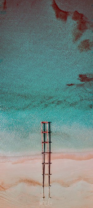 Aerial view of a wooden pier on a tropical beach