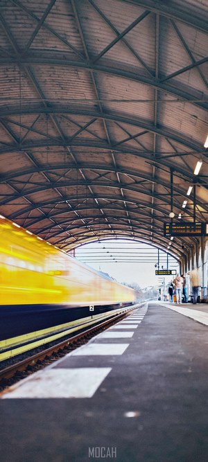 Yellow train at a covered station platform