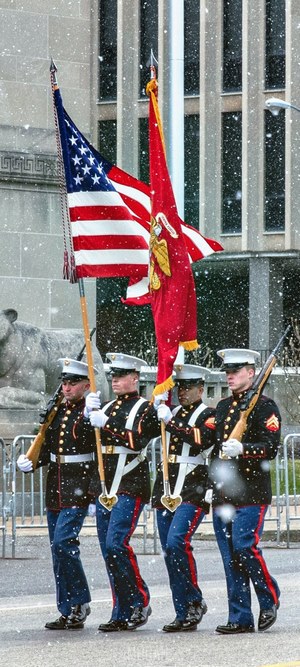 US Marines marching with flags in the snow