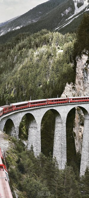 Red train on Landwasser Viaduct in mountains